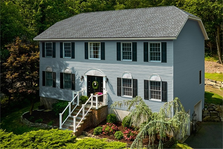 Light blue house with Timberline HDZ® Shingles in Pewter Gray.